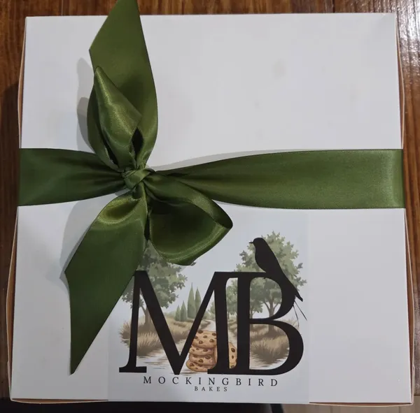 Mockingbird Bakes, Leander. White box, green ribbon, the bird, and cookies