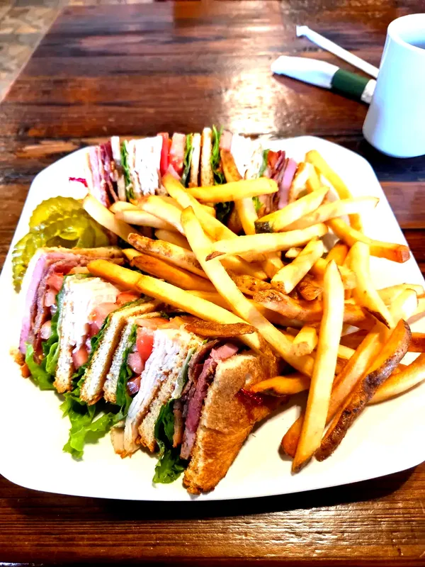 Leander's club sandwich, fries, and pickles. No surprises, just heft